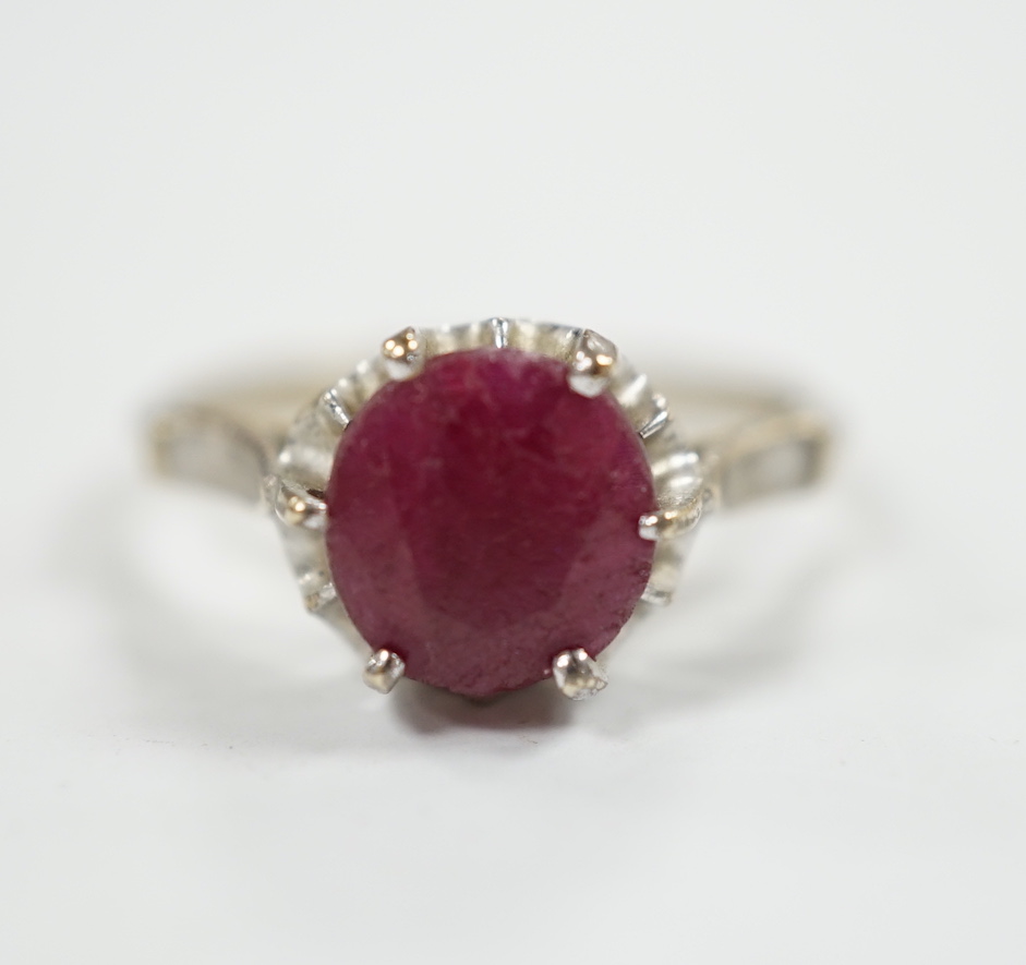 A 750 white metal and solitaire ruby set ring, size M/N, gross weight 3.1 grams.